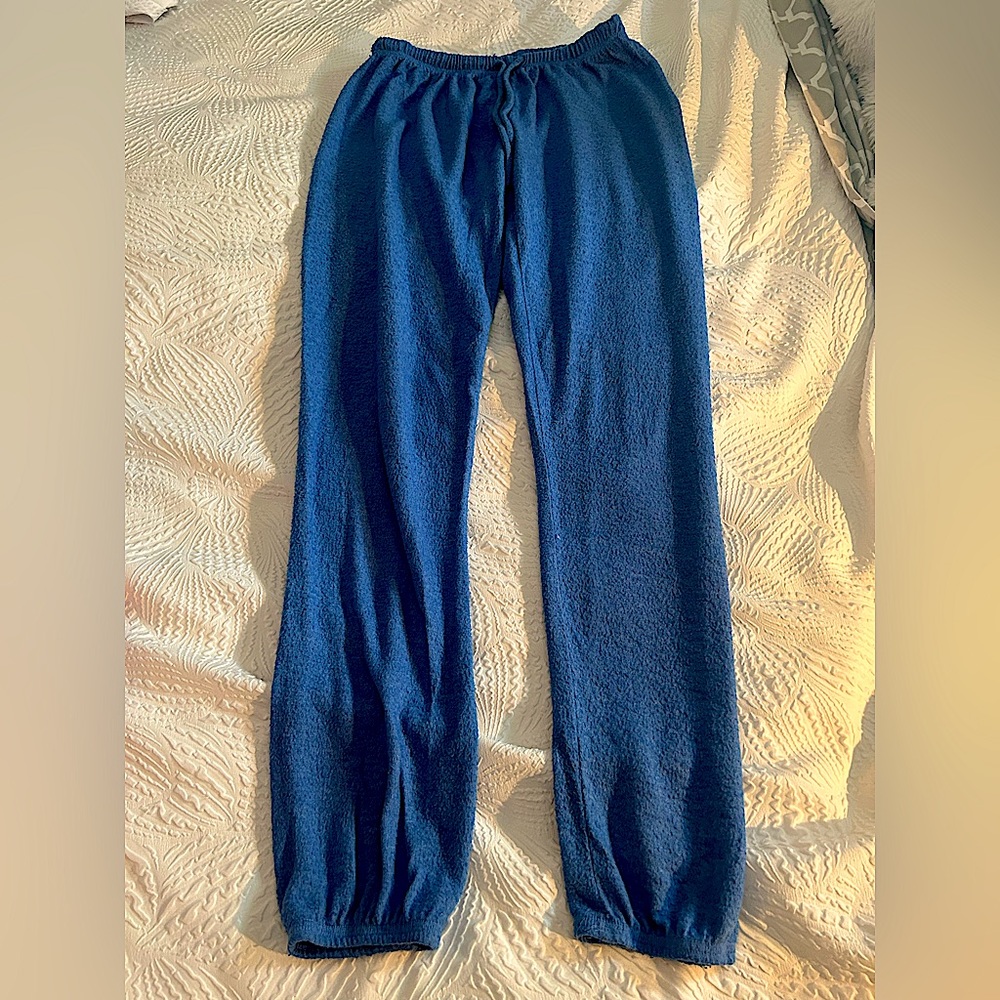 Small, blue cuffed bottoms sweatpants with pockets and with string.